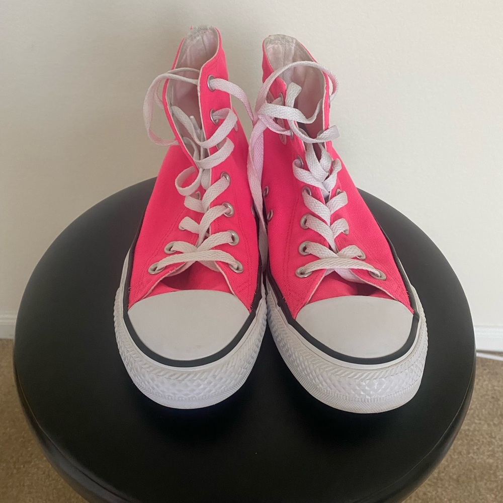 Hot pink Converse high top shoes for women.